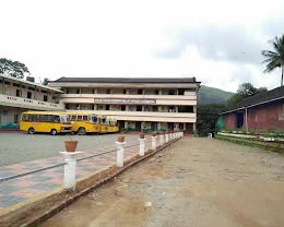 School buses parked in front of the main building