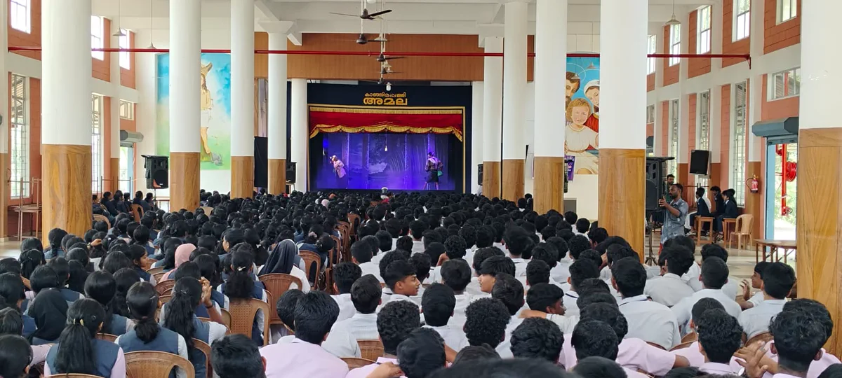 Students filling the school auditorium for a stage programme